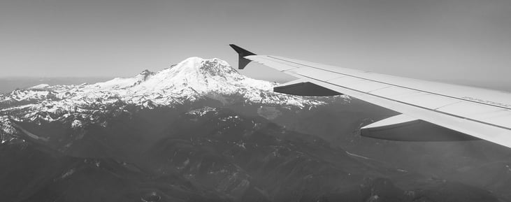 View of mountain and wing from an airplane
