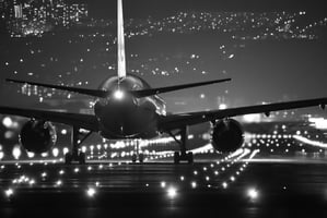 Night view of plane on runway with lights 