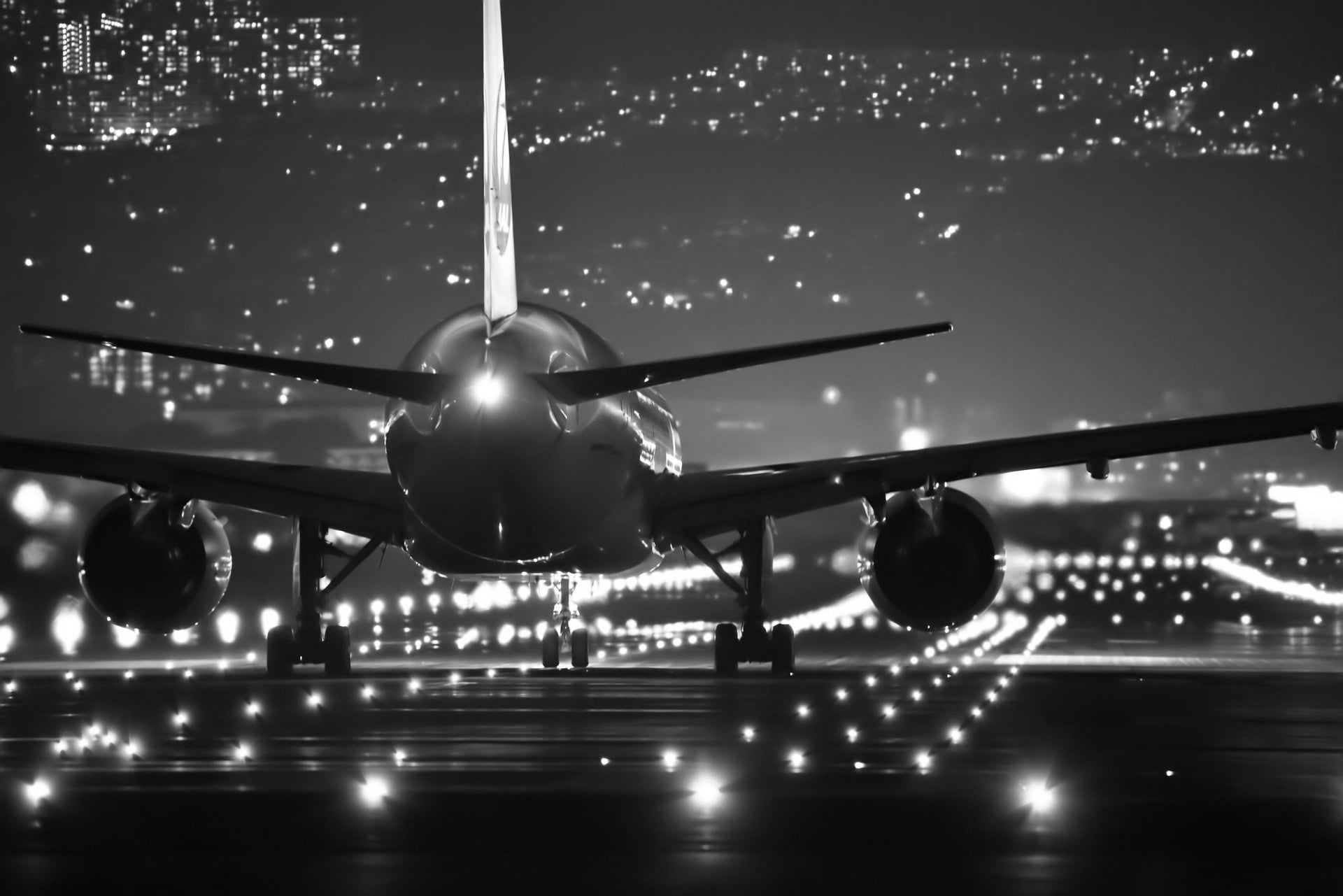 Night view of plane on runway with lights 